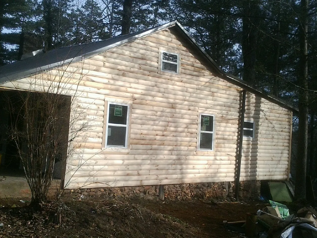 New log siding and dark metal roofing on a gable end in Chincoteague Island
